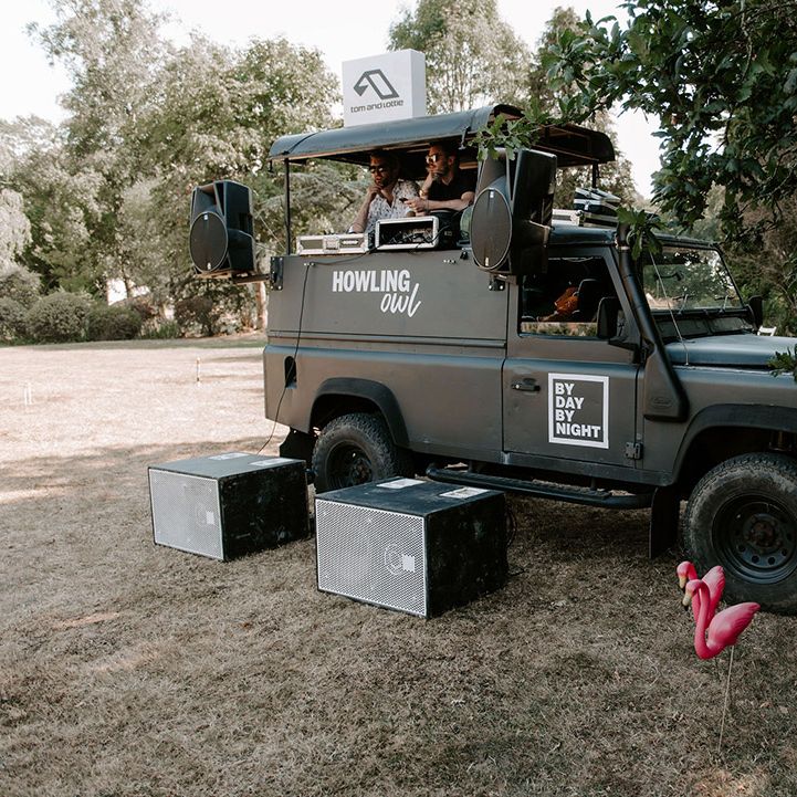 Outdoor black truck DJ booth on the lawn for the wedding 