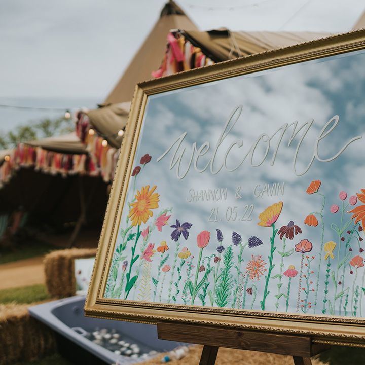 Gold mirror wedding sign with colourful floral illustration 