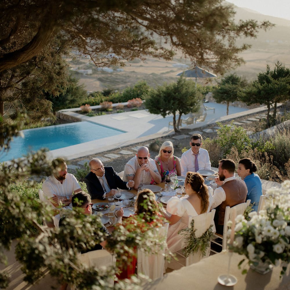 Private villa wedding with white and green floral tablescape, swimming pool and views of the Grecian hills
