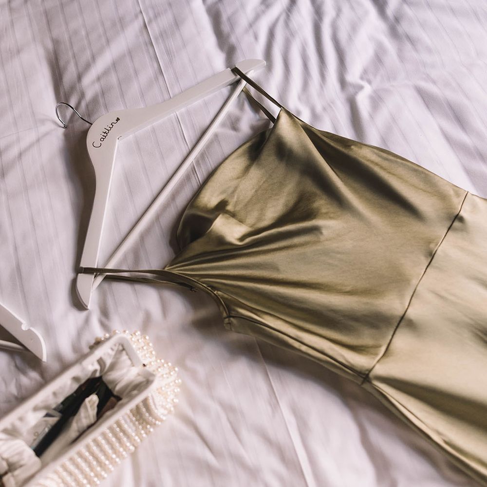 White hanger personalised with name with sage green bridesmaid dress from Pretty Lavish 