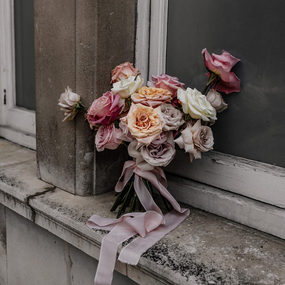 Romantic pink, peach, lilac and white peeled back rose wedding bouquet 