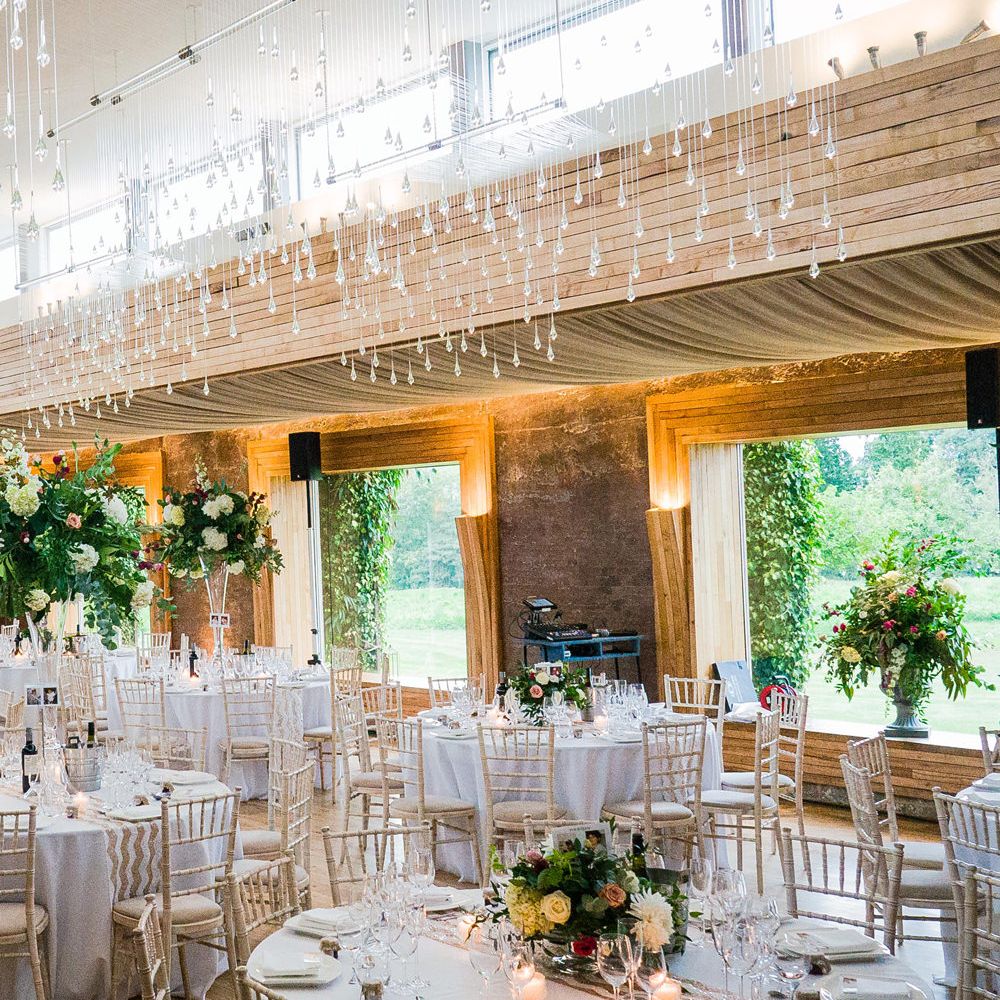 Elegant wedding reception at Elmore court with brightly coloured floral decorations