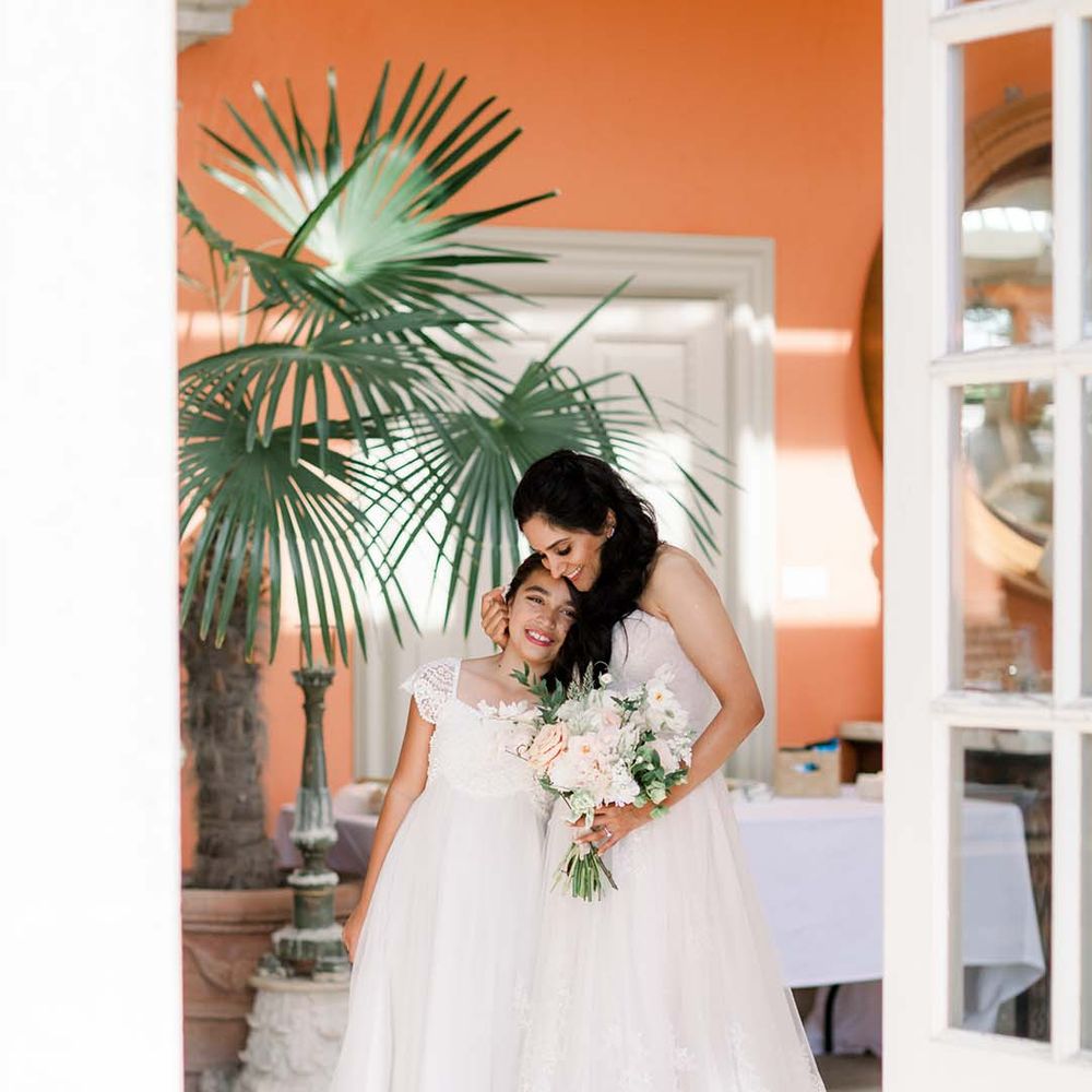 Bride hugs flower girl in The Orangery at Euridge Manor
