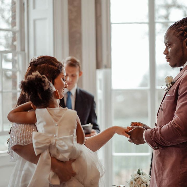 Bride & groom hold hands on their wedding day