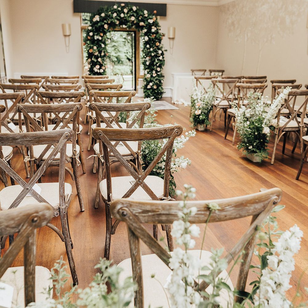 Foxhill Manor wedding ceremony decor with floral arch and aisle wedding flowers 