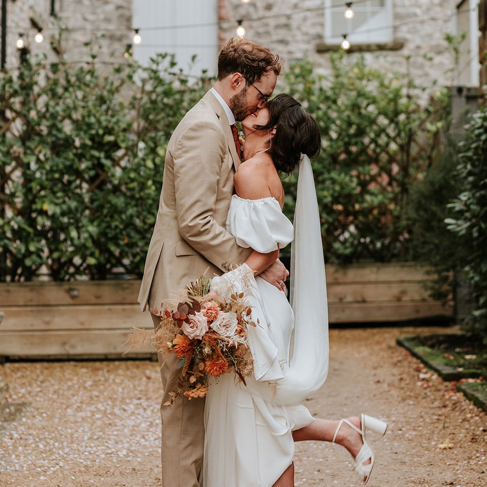 Bride has her foot popping moment as she shares a kiss with her new husband