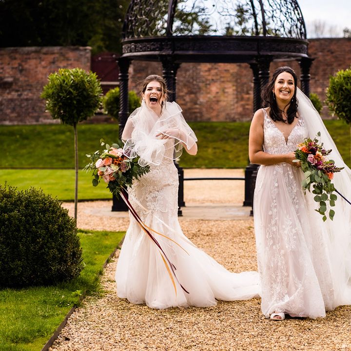 Brides walk their pet dog in colourful bow tie collar who was ring bearer during the ceremony