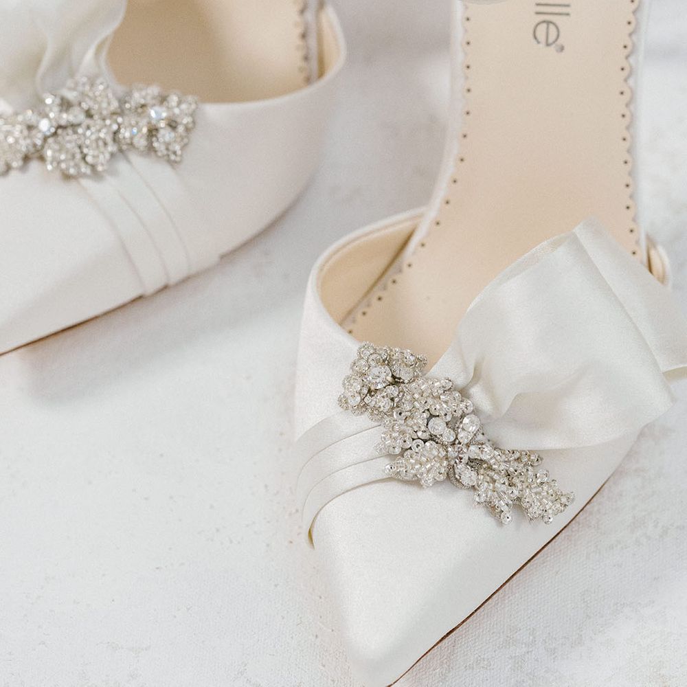 White satin pointed wedding stilettos with ruffle detail and crystal embellishment 