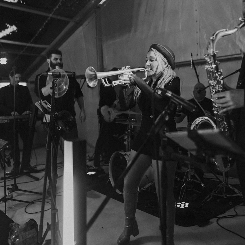 Brass band wedding entertainers at clear glass marquee wedding reception 