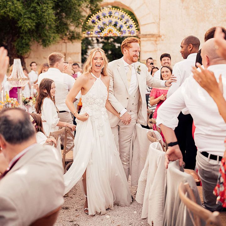 Bride and groom greet their wedding guests as they enter their wedding reception 