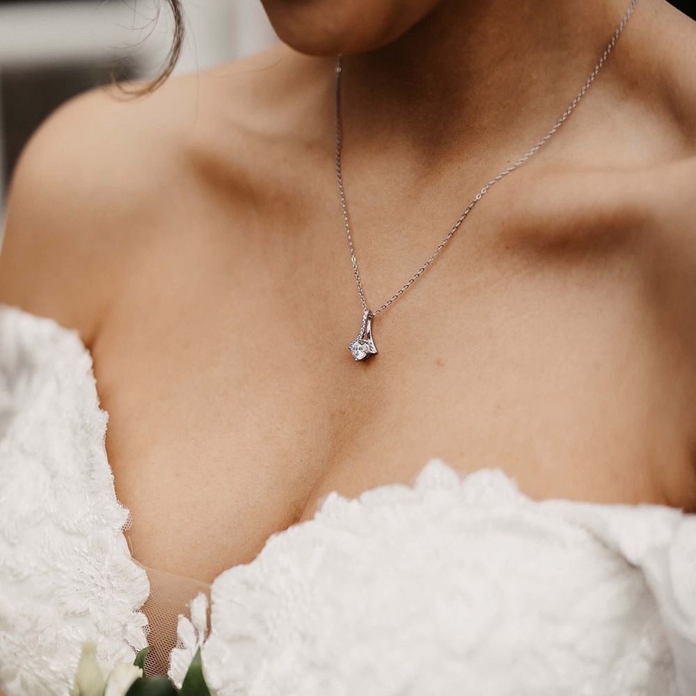 Bride wearing a silver necklace with a diamond pendant bridal jewellery