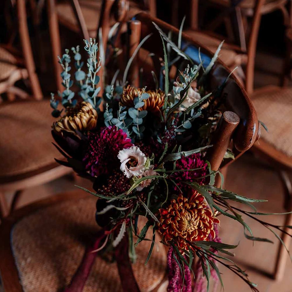 Autumnal dried flower bouquet with peonies, foliage and roses