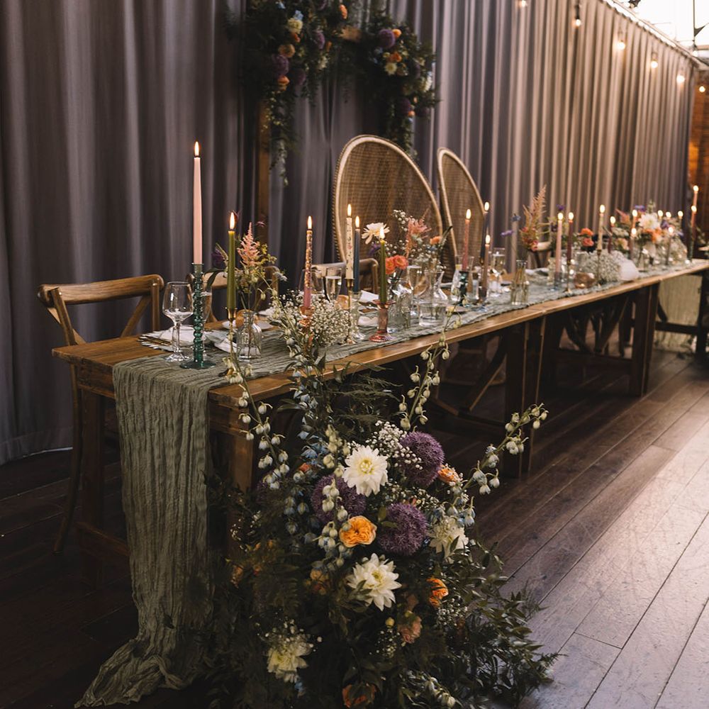 Boho peacock chairs at the top table for botanical wedding with pastel wedding decorations 