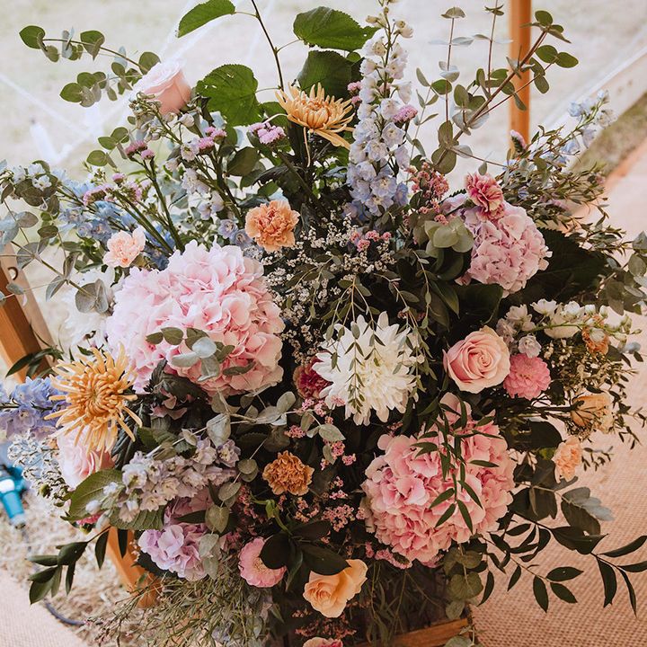 Pastel coloured pink and white wedding flower arrangements 