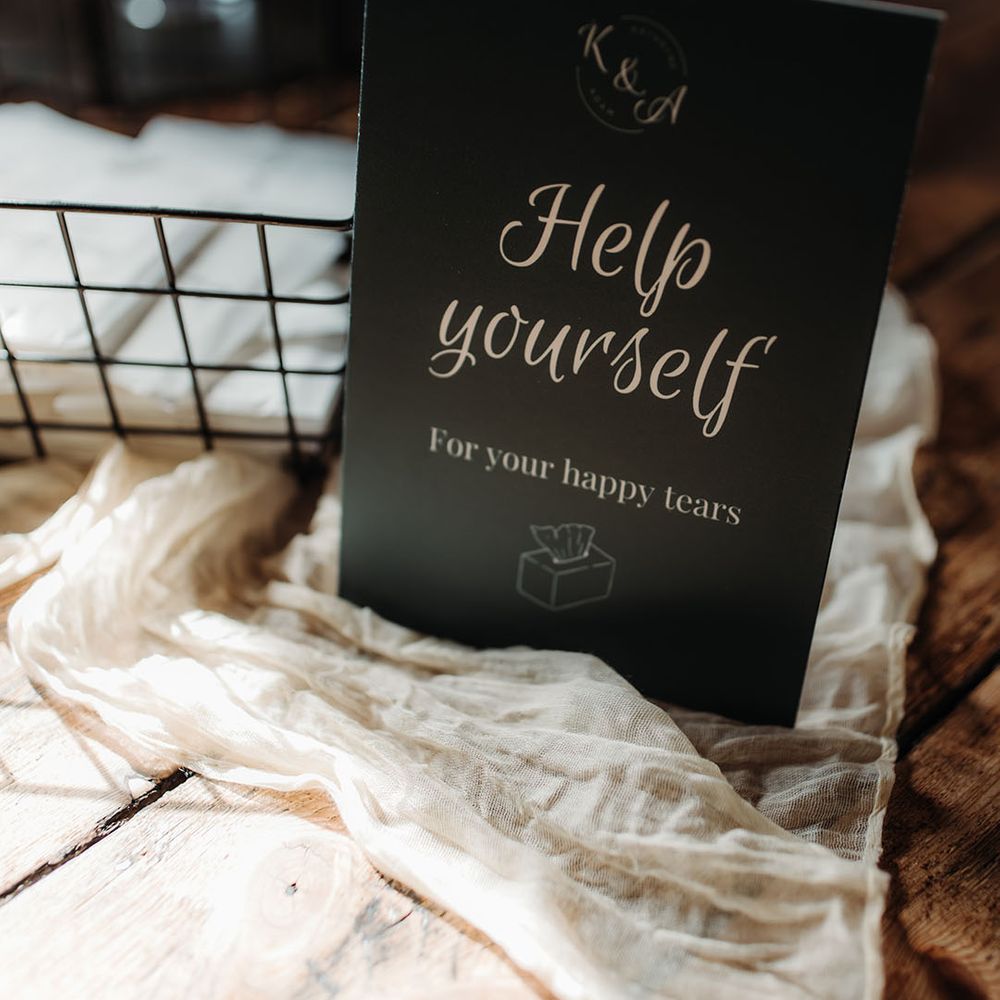 Dark green wedding sign asking guests to help themselves to tissues for the wedding ceremony 
