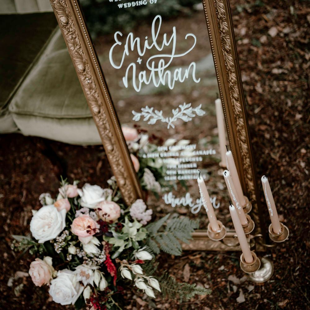 Vintage mirror wedding welcome sign with flower and candlestick decor 