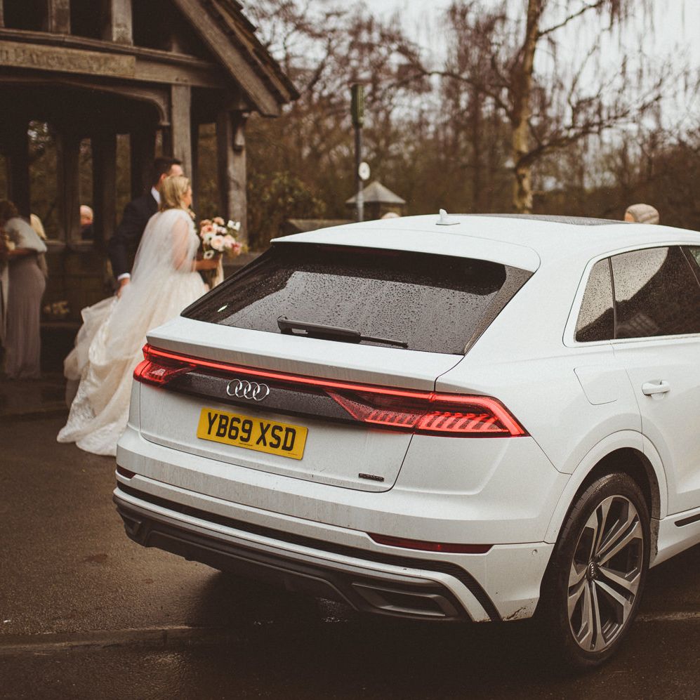 White Audi wedding cake outside the church