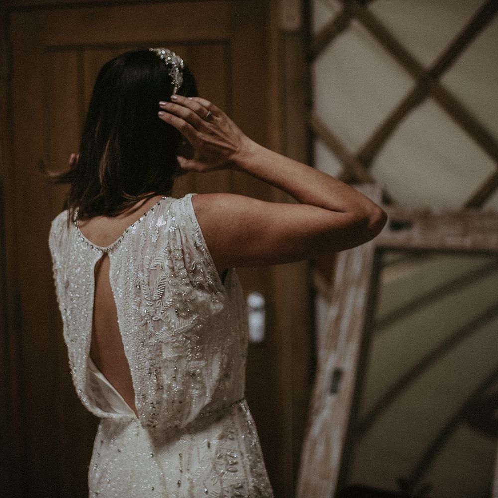 Bride looks in the mirror as she gets ready on the day of her wedding