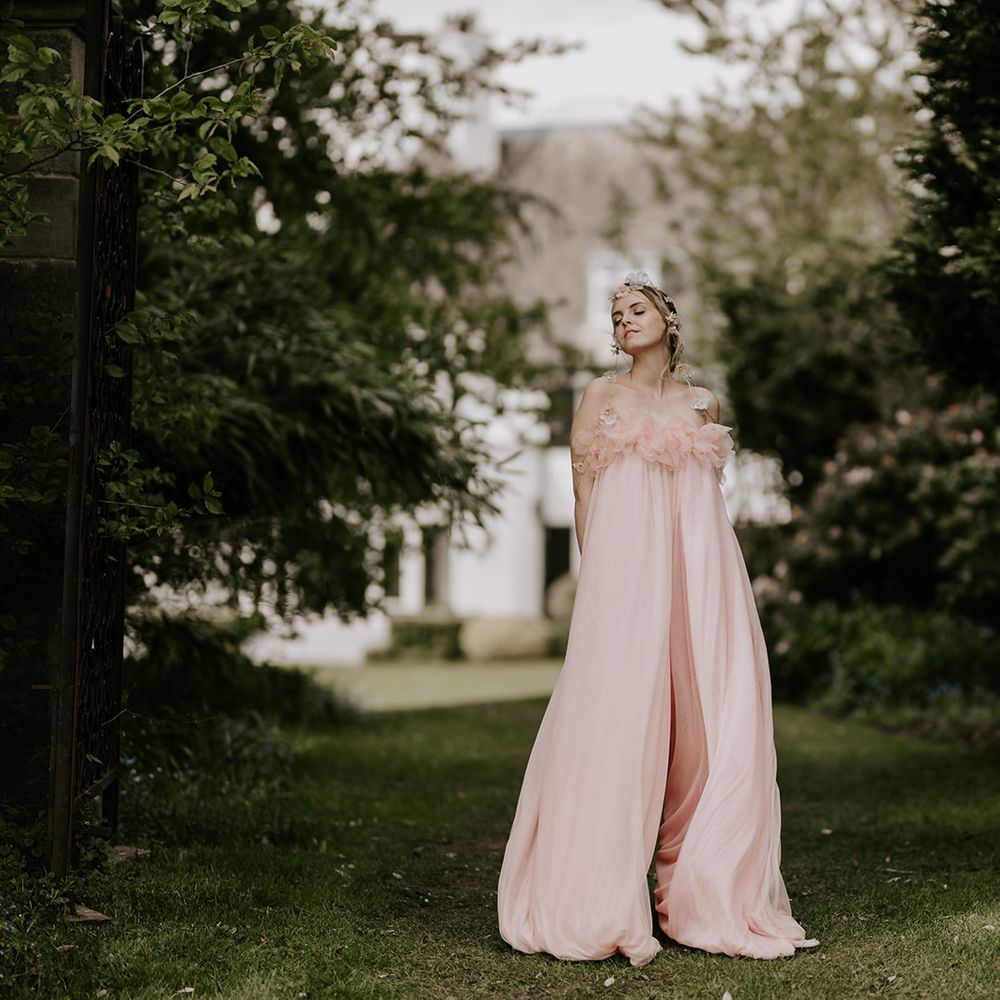 Boho bride in a blush pink jumpsuit by Felisiti Greis with a chain headdress 