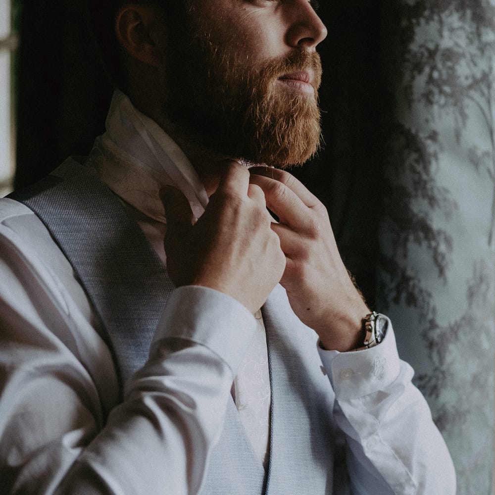 Groom gets ready for country house wedding