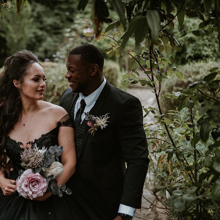 Bride & groom look lovingly at one another 