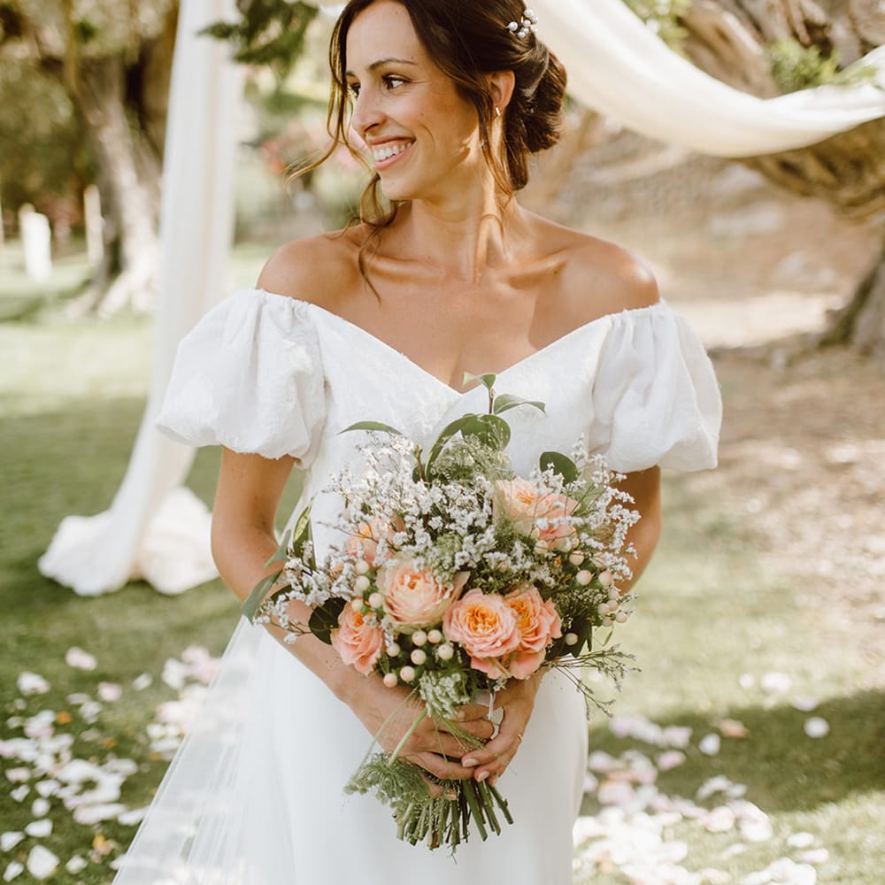 smiling bride holding pink and white bouquet 