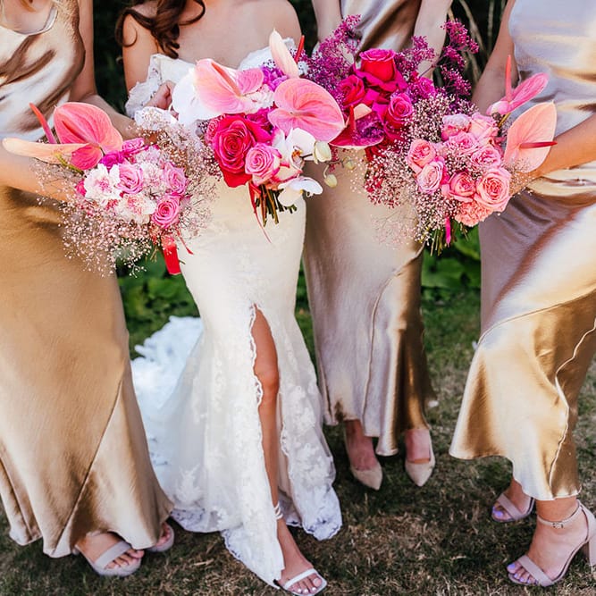 Bright pink floral bouquets filled with anthuriums and roses 