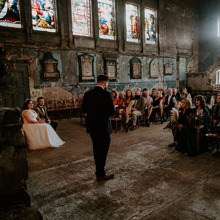 Guest does wedding reading at industrial wedding venue in London