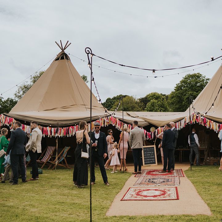 Outdoor tent with colourful bunting for wedding reception at Burrow Farm Gardens 