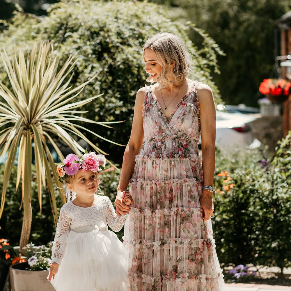 Bridesmaid and flower girl walking at the wedding during summer 