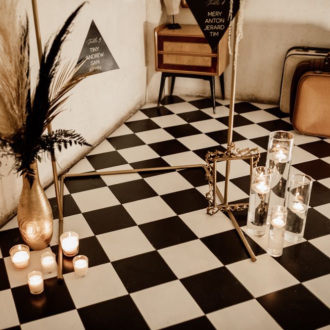 Black & white tiled floor with floral display with pampas grass