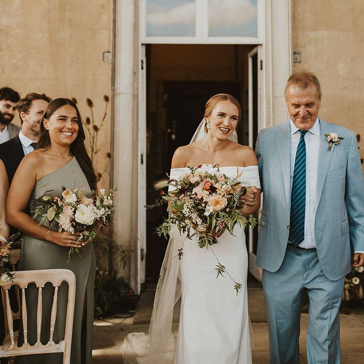 Bride walks down the aisle on her wedding day with her father 