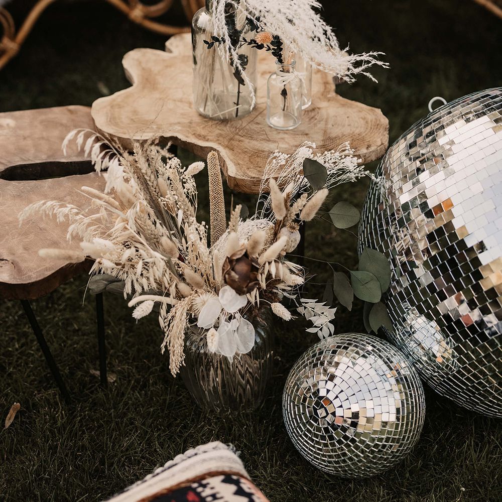 Dried florals in clear vase on wooden plank