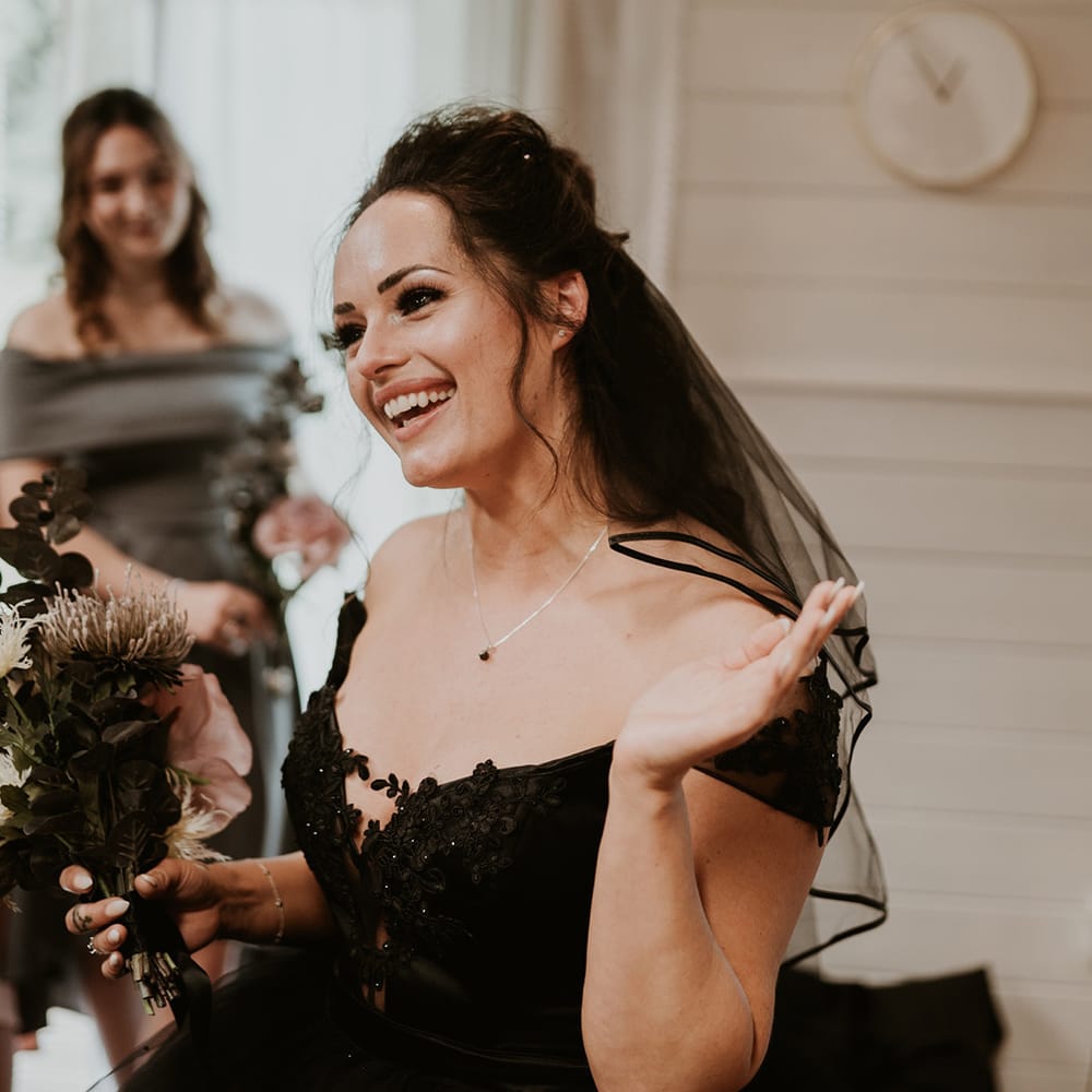 Bride wears homemade strapless black wedding dress and black veil 