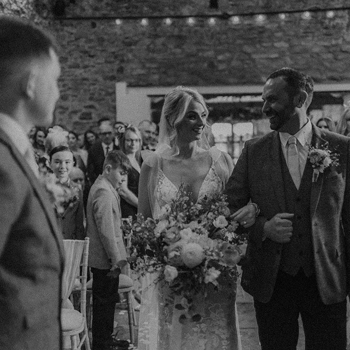 Father of the bride walks the bride in Made With Love dress down the aisle to groom at Eden Barn wedding venue 