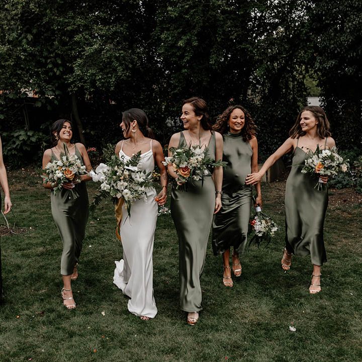 Bride and bridesmaids in white and sage green satin dresses 