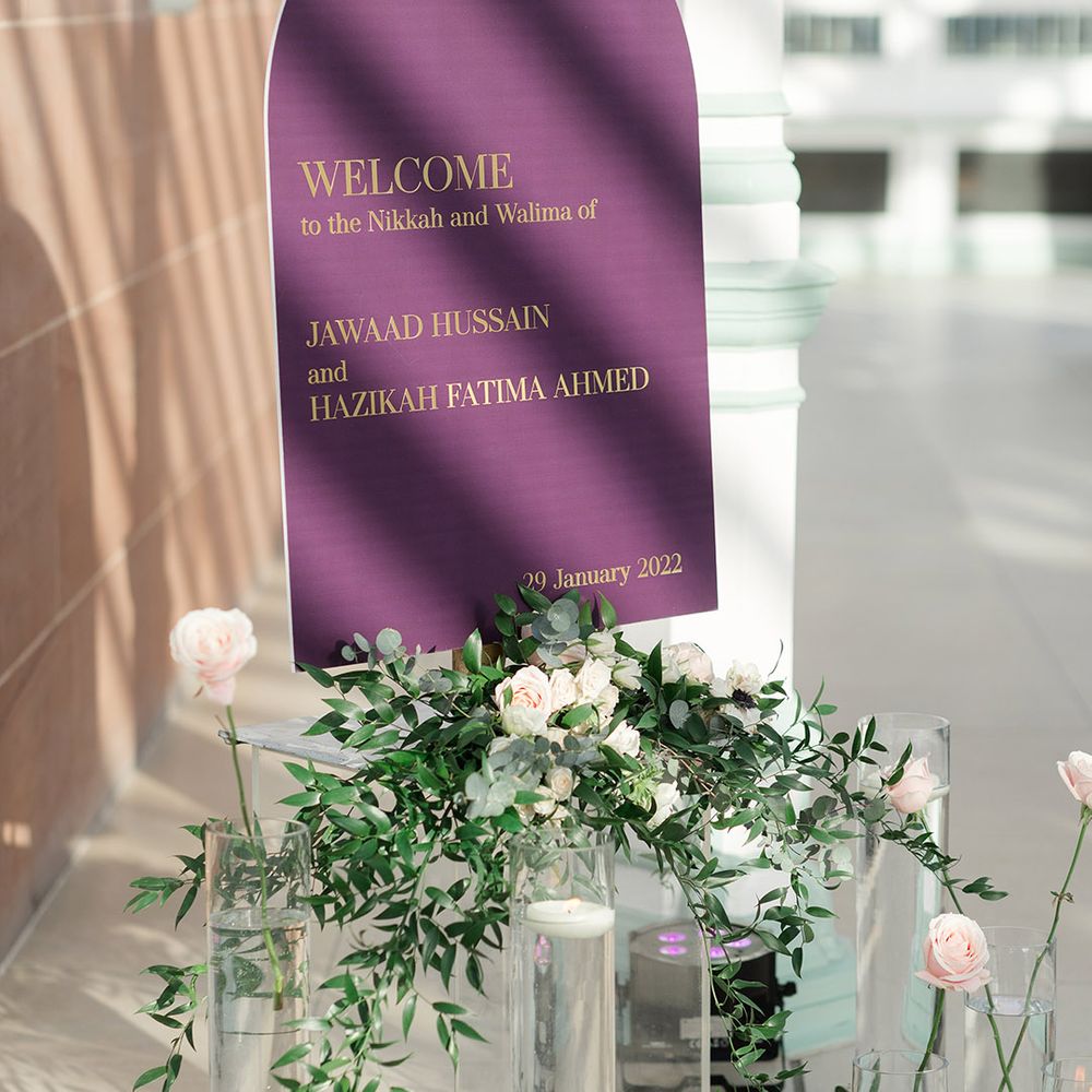 Purple sign complete with gold writing welcoming people to the Nikkah & Walima 
