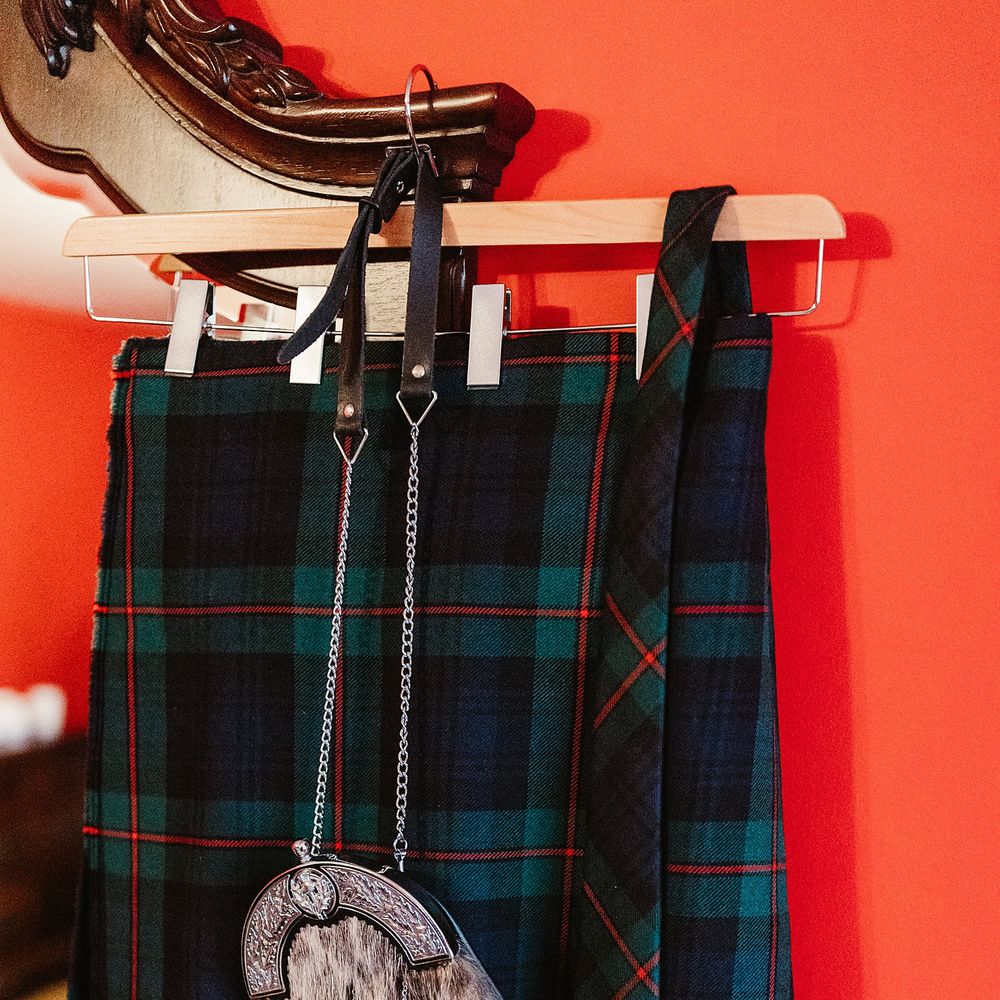 Tartan kilts hang on the morning of wedding day