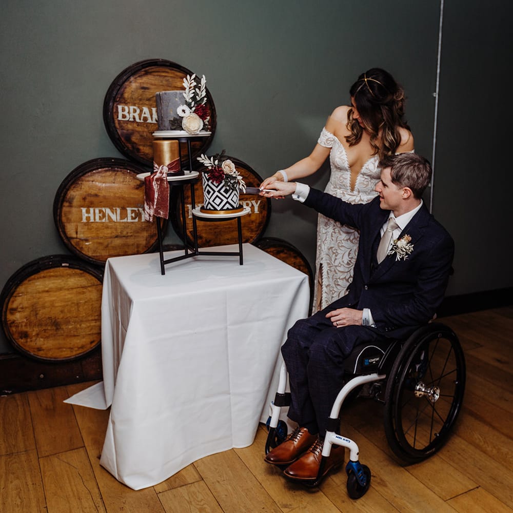 Bride and groom cut their geometric black and white patterned wedding cake 