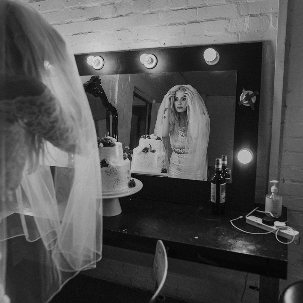 Bride in boho two piece lace bridal outfit getting ready for modern stylish London wedding