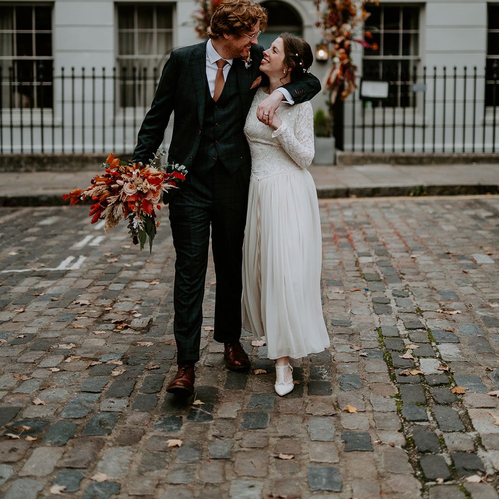 Bride and groom looking into each other's eyes walking outside The Zetter Townhouse at intimate, autumnal London wedding