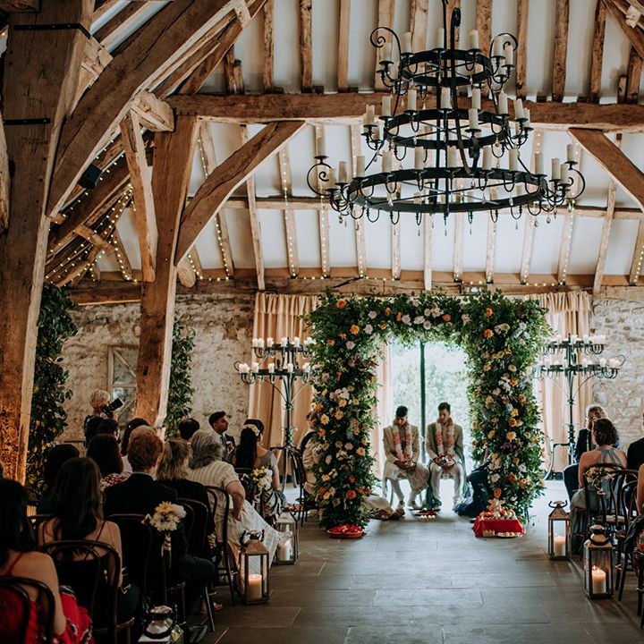 The Tithe Barn Bolton Abbey wedding complete with colourful floral arch and multicultural ceremony 