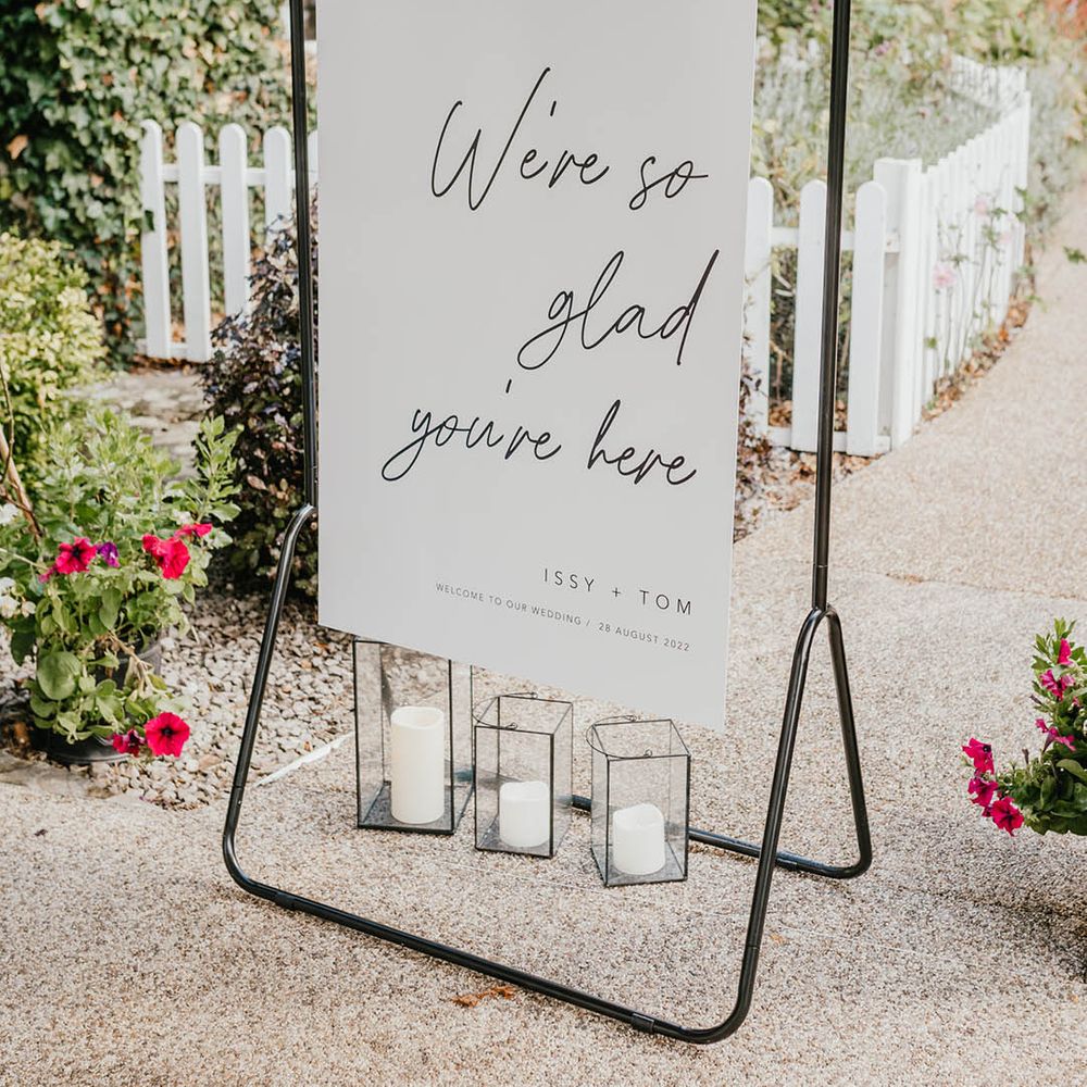 Black and white calligraphy wedding welcome sign on black metal frame for the minimal and monochrome wedding