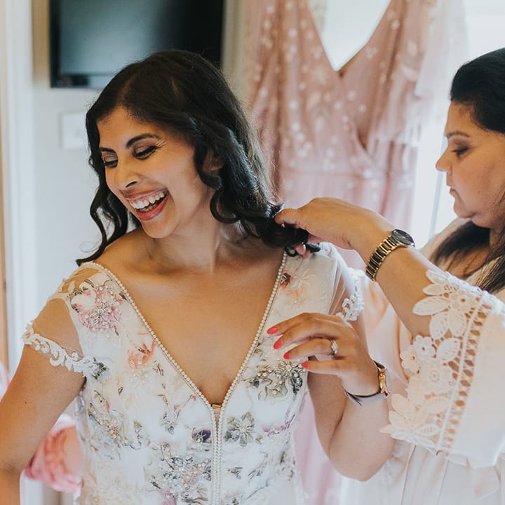 wedding morning bridal preparations with Indian bride in a floral Savin London Amelia wedding dress