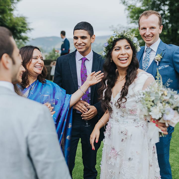British Indian bride in a Savin London Amelia Dress with her groom in a light blue suit 