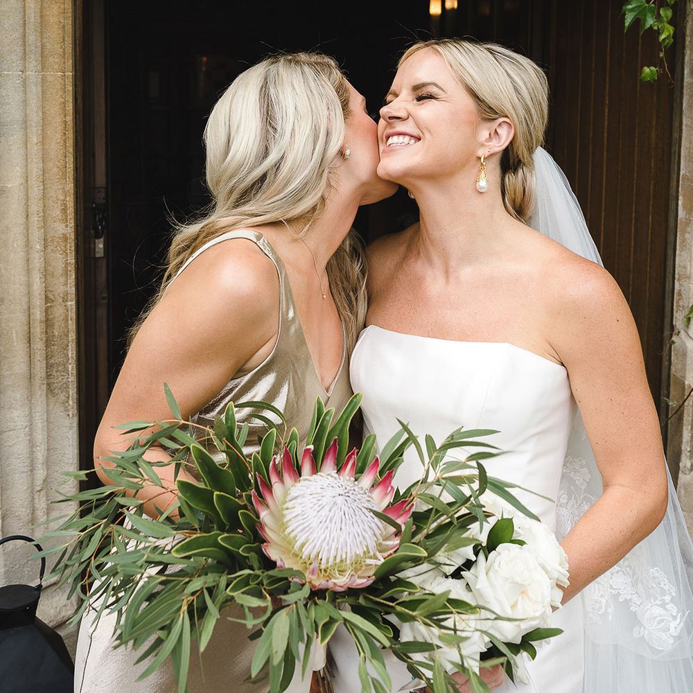 Bridesmaid holding King Proteas bouquet to represent the country where the bride and groom got engaged 