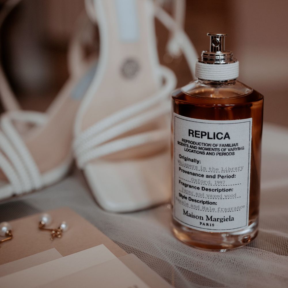 Bride's wedding scent perfume with white wedding shoes and mini pearl earrings 