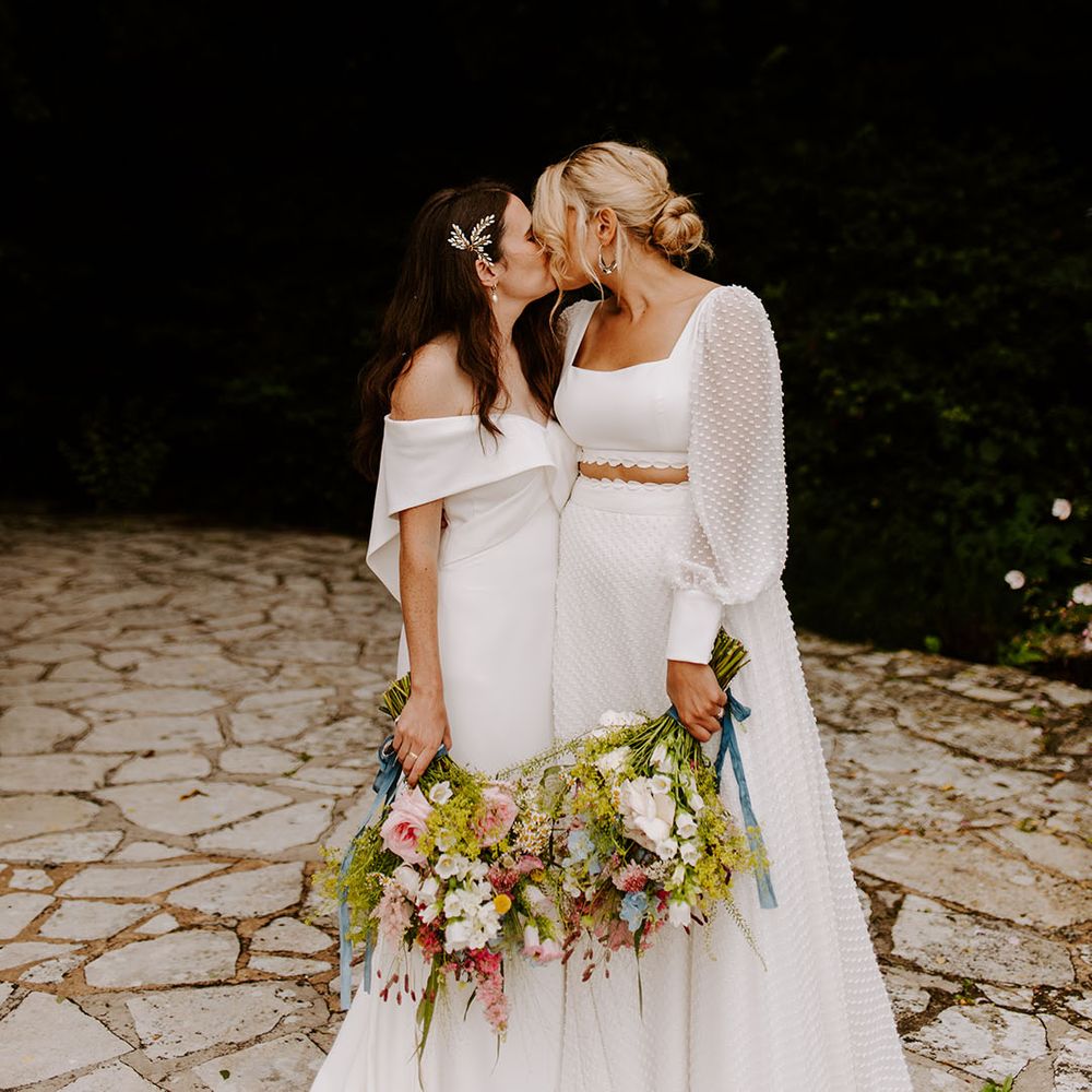 Lesbian wedding with same sex couple posing for romantic couple portrait 