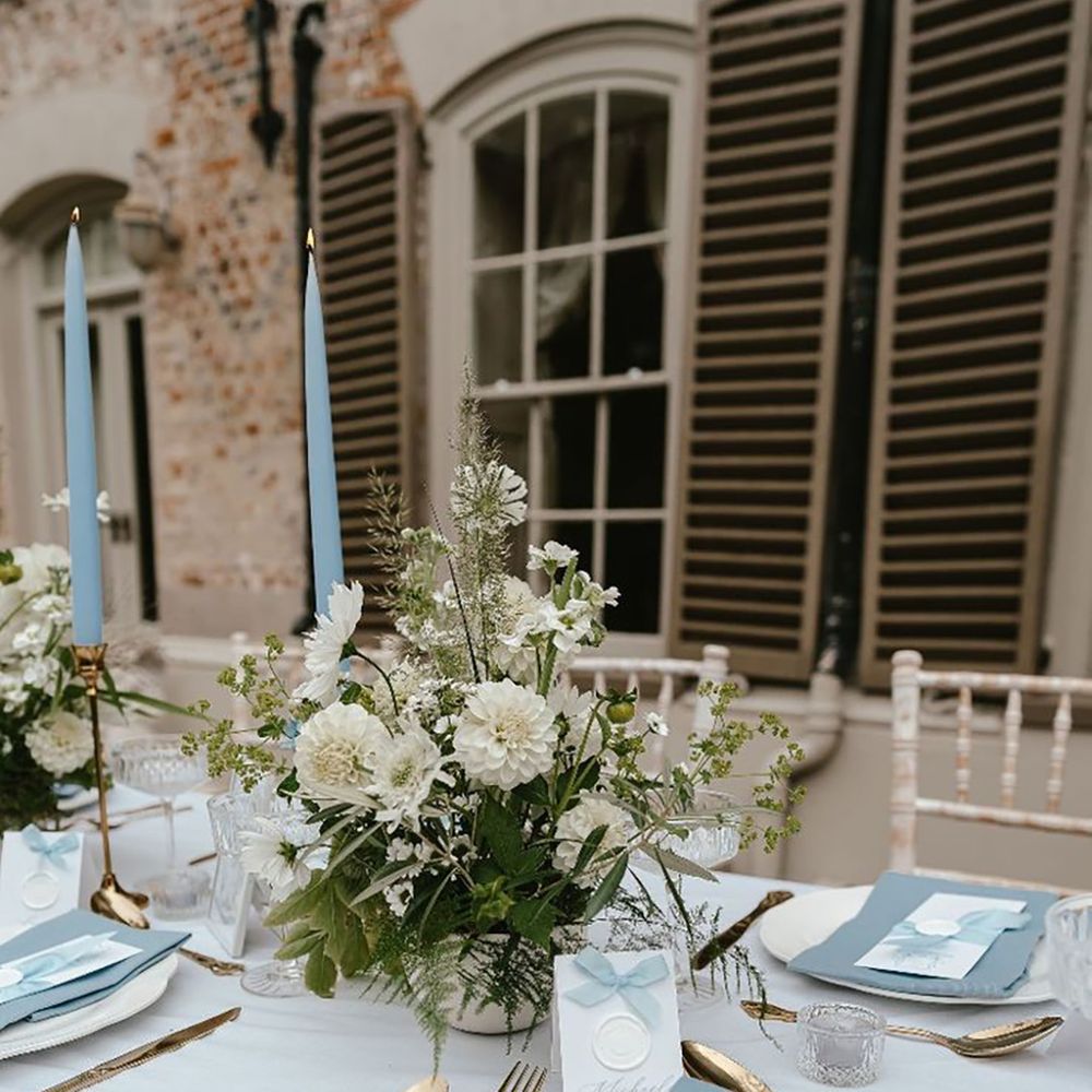 Blue bow wedding place names with blue napkins and wedding menus for the place setting 
