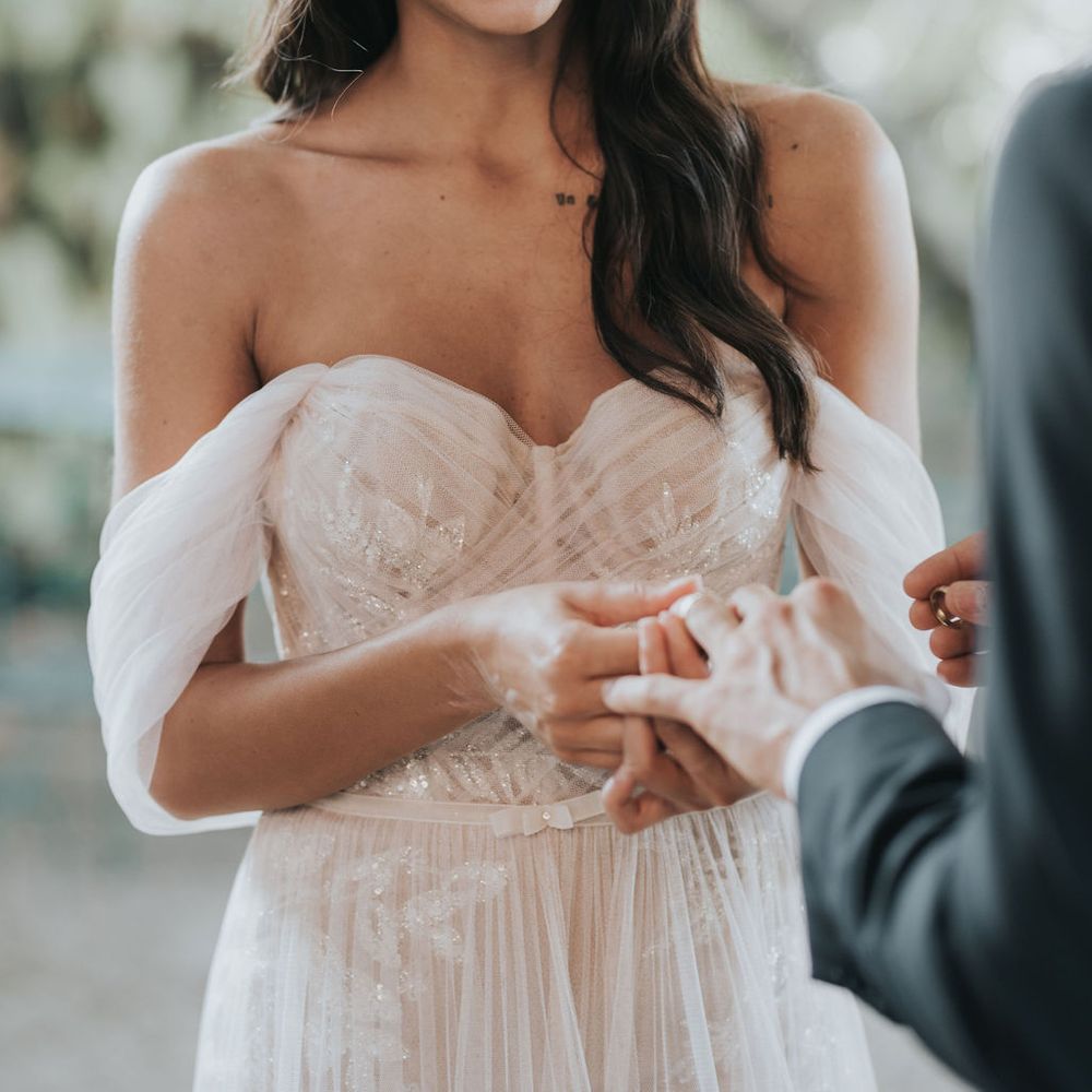 Bride and groom exchanging rings at intimate Tuscany elopement 